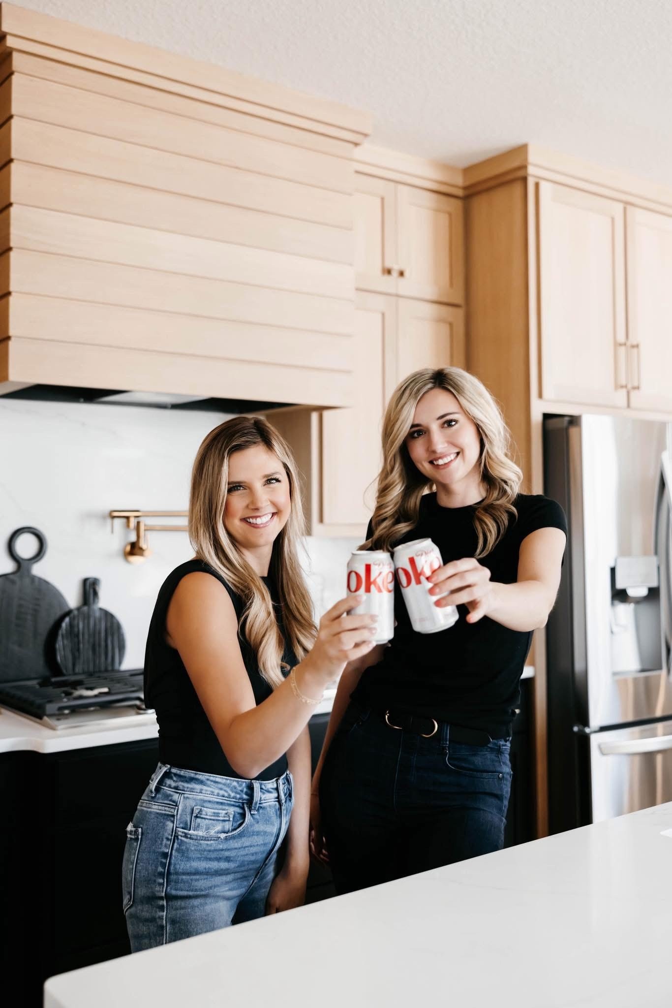 Ashland and Olivia sharing a Diet Coke toast
